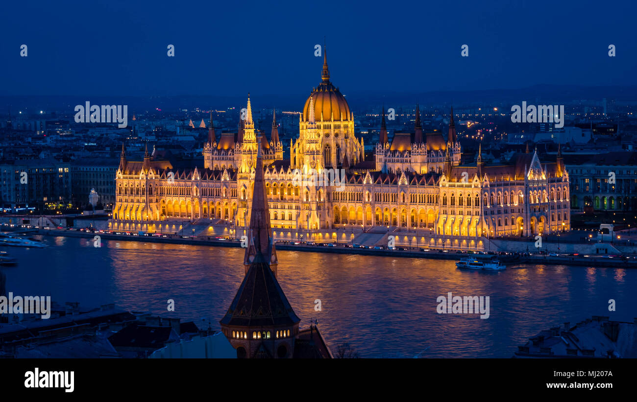 Parliament of Budapest after sunset seen from the opposite river bank Stock Photo