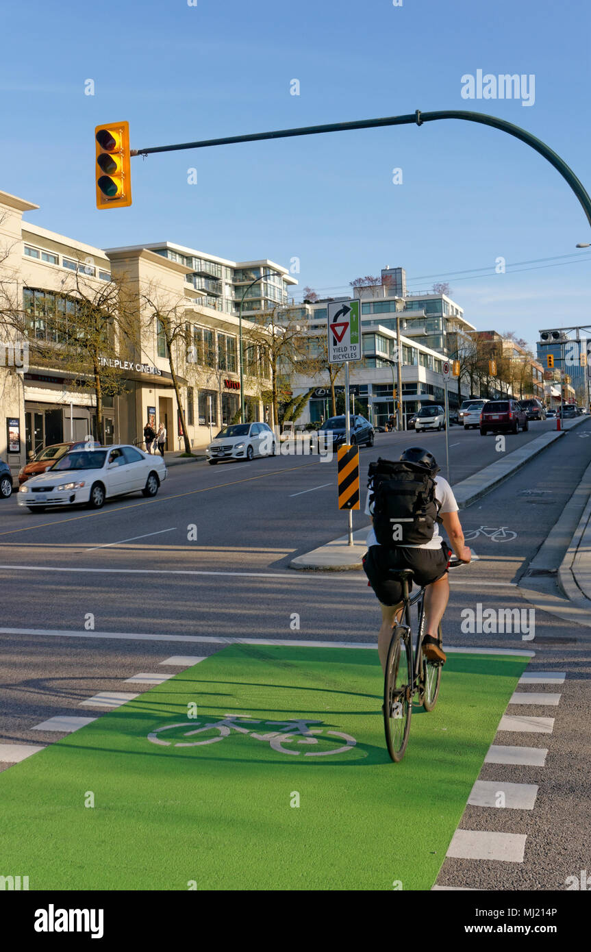 Cyclist in the bike lane on Burrard Street in Kitsilano, Vancouver, BC, Canada Stock Photo