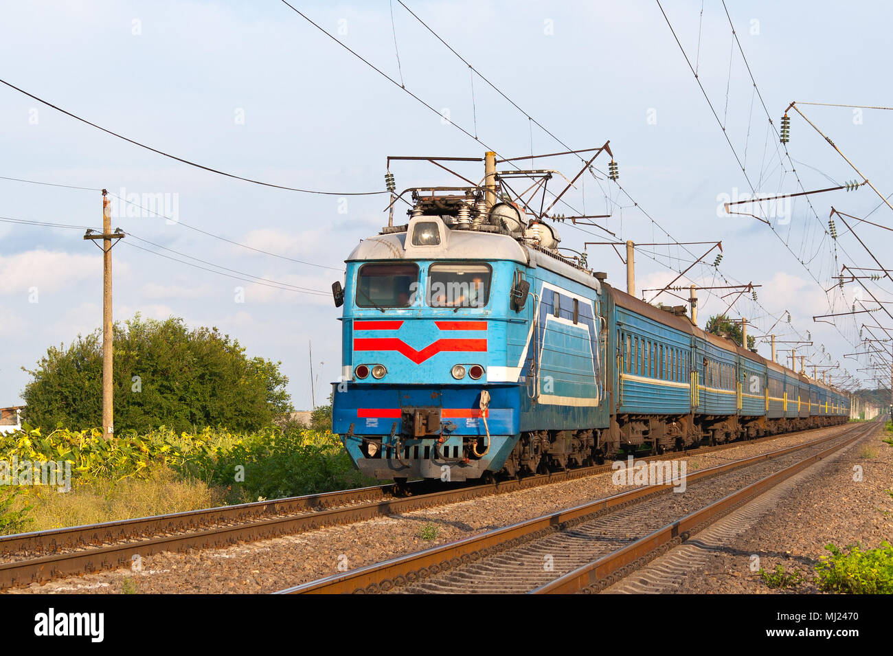 Passenger train hauled by electric locomotive Stock Photo