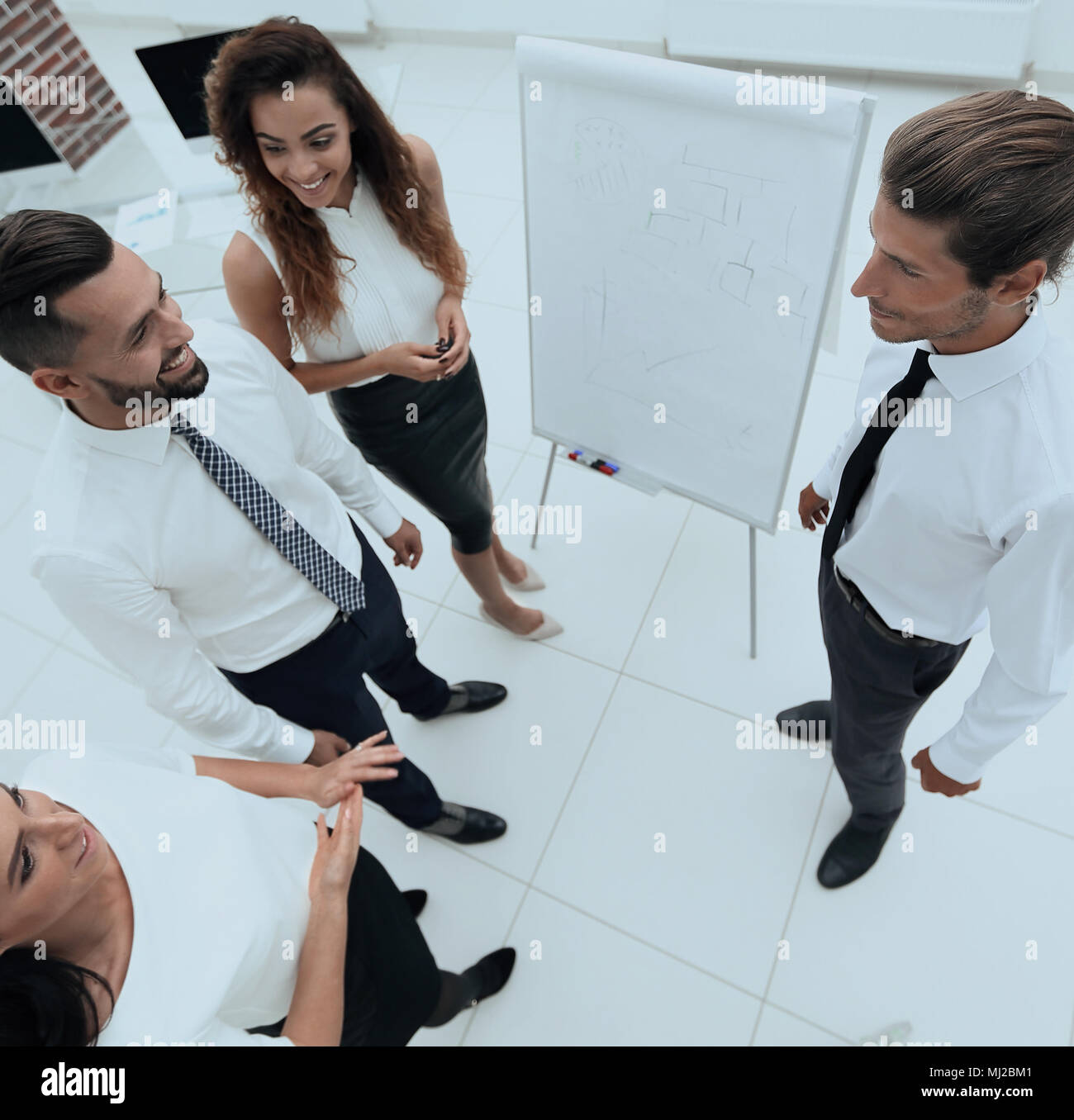 business team standing in front of a flipchart Stock Photo - Alamy