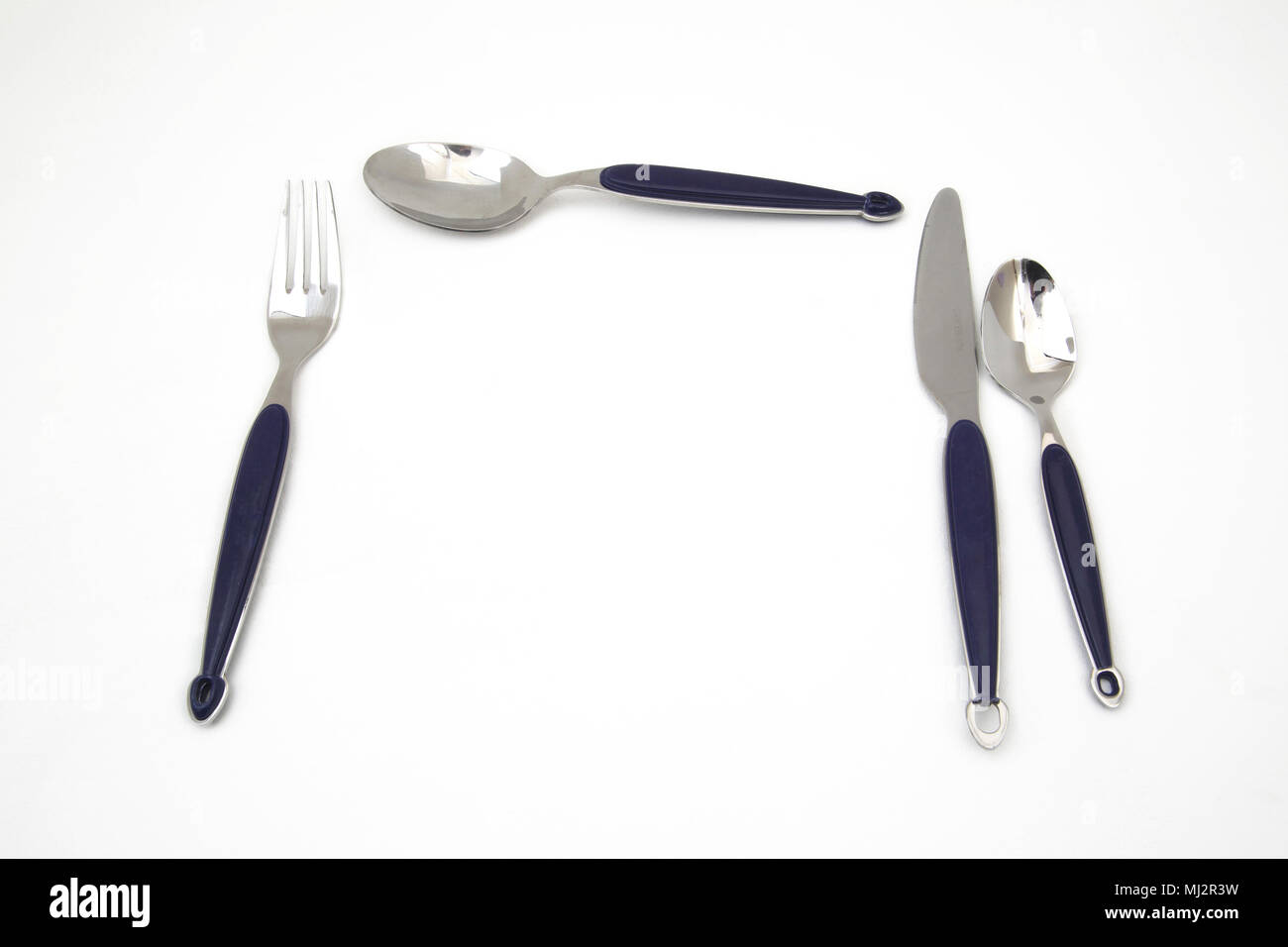 Set of Stainless Steel Cutlery With Blue Plastic Handles Stock Photo