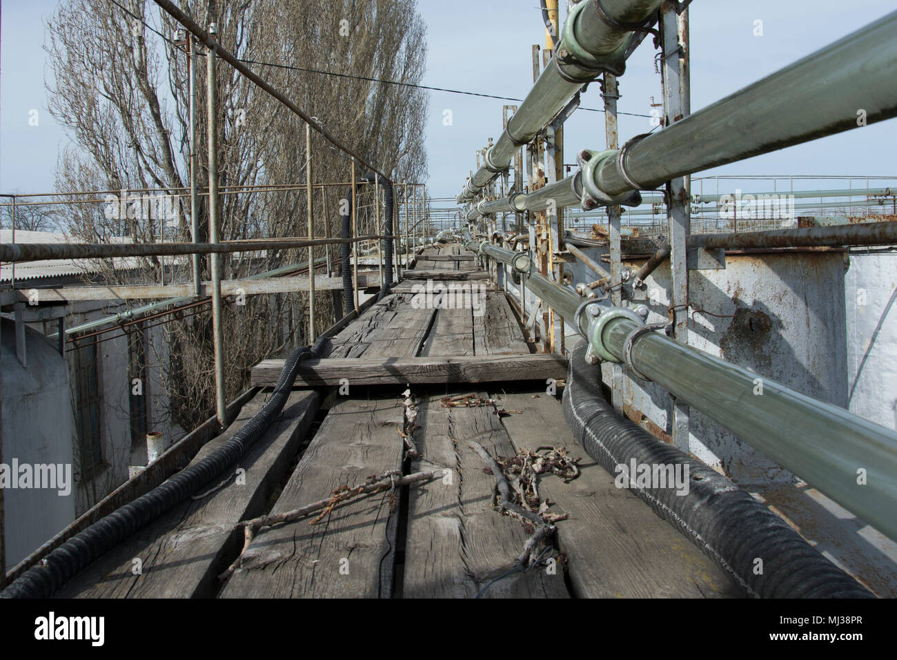 on a platform the remains not of the rabotyushchy glass pipeline on which wine, with rusty capacities arrived Stock Photo