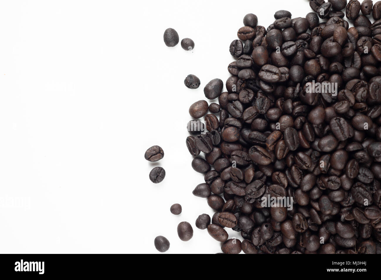 Roasted coffee beans on white background. Select focus shallow depth of field with copy space Stock Photo