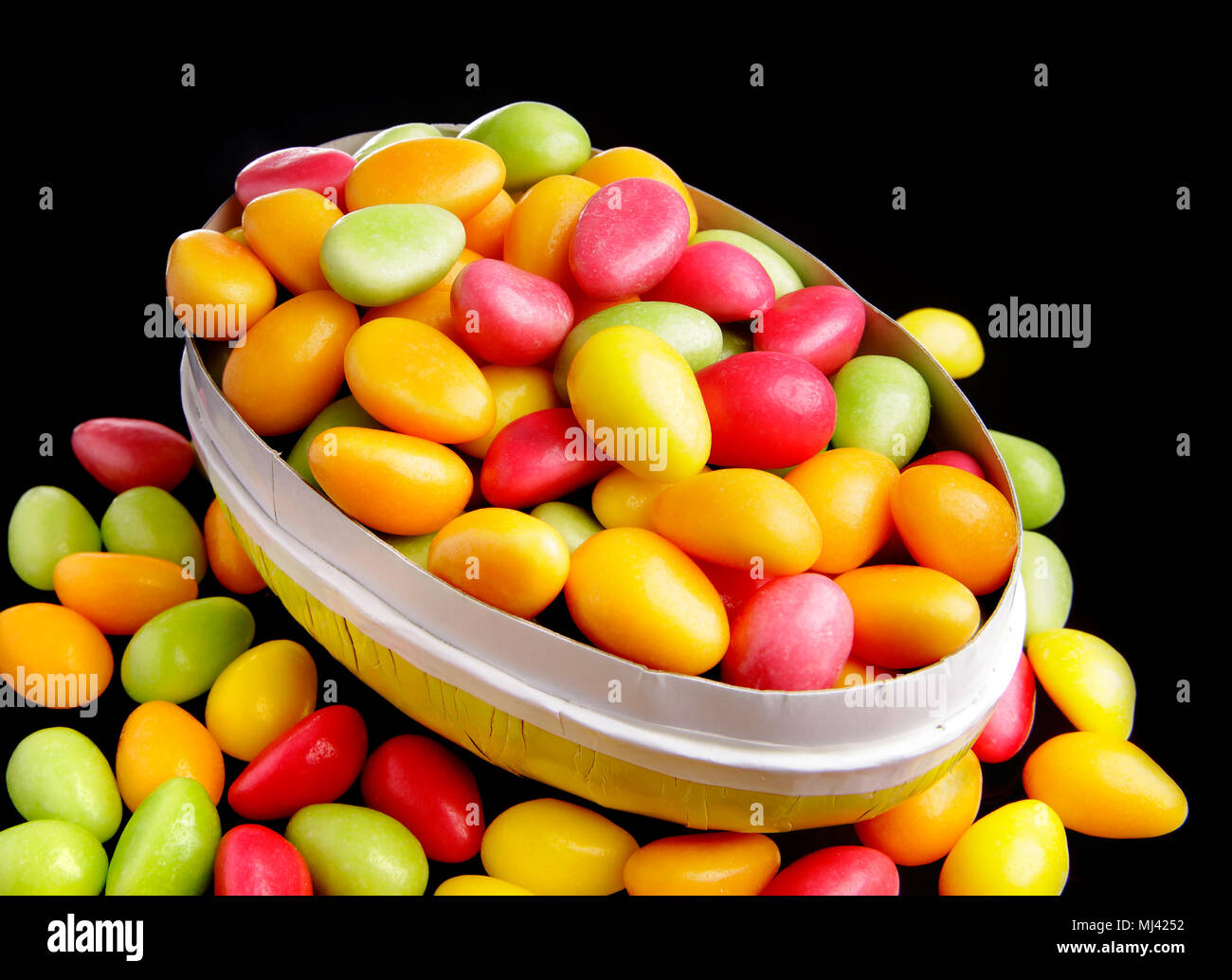 An opened Easter eggs filled with Easter candy eggshaped, with some of