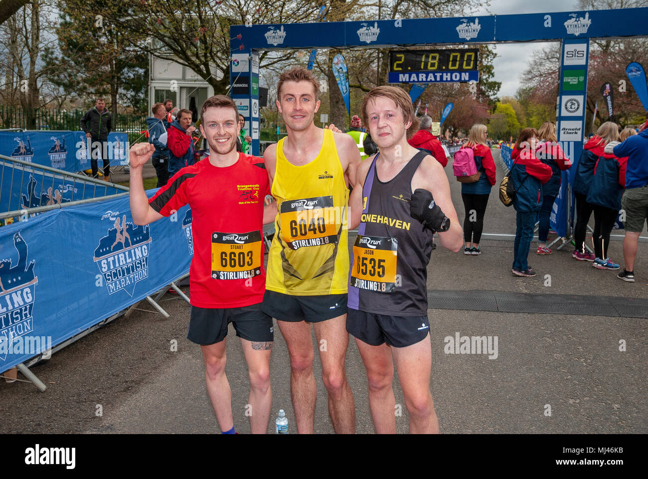 Michael Crawley (C), Stuart Paterson(L) and Jason Kelly (R) pose for photographers after completing the 2018 Stirling Scottish Half Marathon. Stock Photo