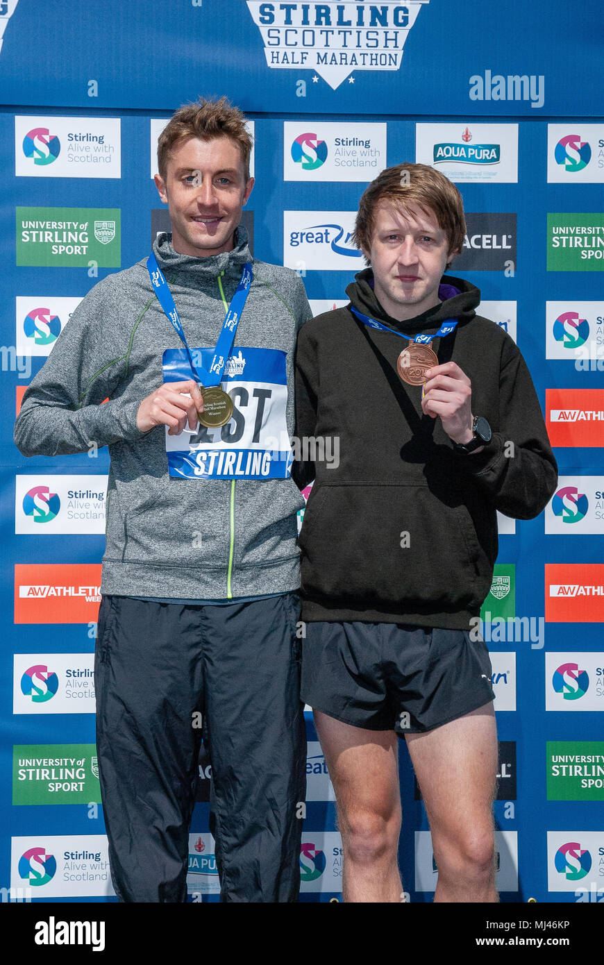 Michael Crawley (C), Jason Kelly (R) pose for photographers on the podium with their medals after completing the 2018 Stirling Scottish Half Marathon. Stock Photo