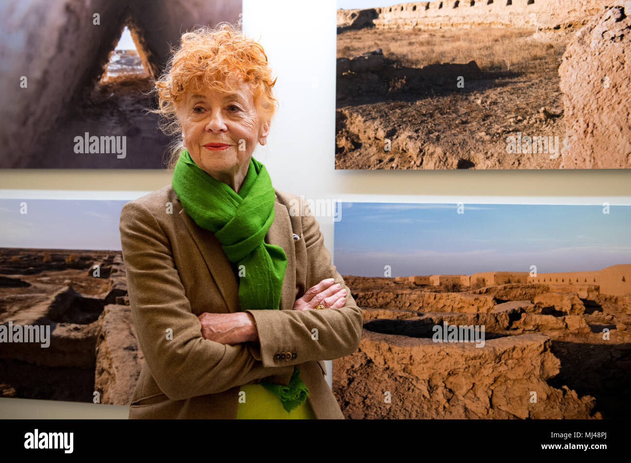 24 April 2018, Germany, Berlin: Photographer Herlinde Koelbl stands infront of one of her photographs at the exhibition 'Margiana. A Bronze Age Kingdom in Turkmenistan'. The special exhibition delivers an insight into a largely unknown 4,000 year old ancient civilisation in eastern Turkmenistan. Photo: Lisa Ducret/dpa Stock Photo