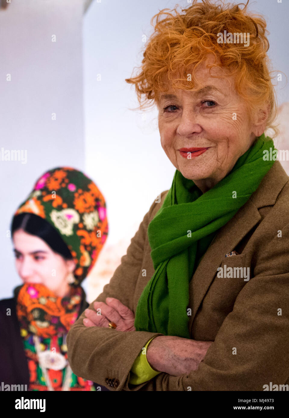24 April 2018, Germany, Berlin: Photographer Herlinde Koelbl stands in front of one of her photographs at the exhibition 'Margiana. A Bronze Age Kingdom in Turkmenistan'. The special exhibition delivers an insight into a largely unknown 4,000 year old ancient civilisation in eastern Turkmenistan. Photo: Lisa Ducret/dpa Stock Photo