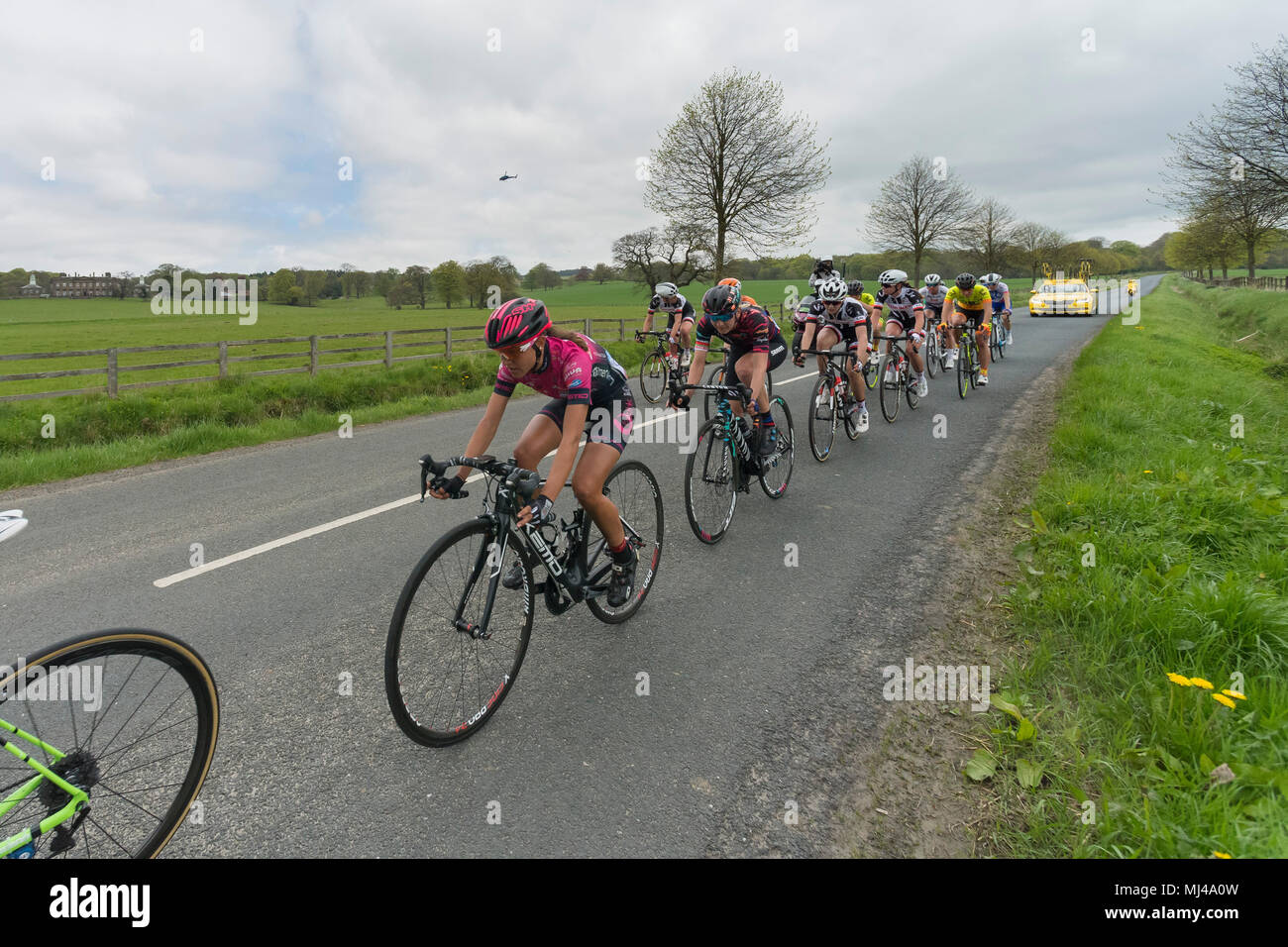 Near Denton, North Yorkshire, 4th May 2018. Close-up of group of female or women cyclists in the Asda Women's Tour de Yorkshire, racing past Denton Hall, on straight countryside lane near Ilkley, North Yorkshire, England, UK. Credit: Ian Lamond/Alamy Live News Stock Photo