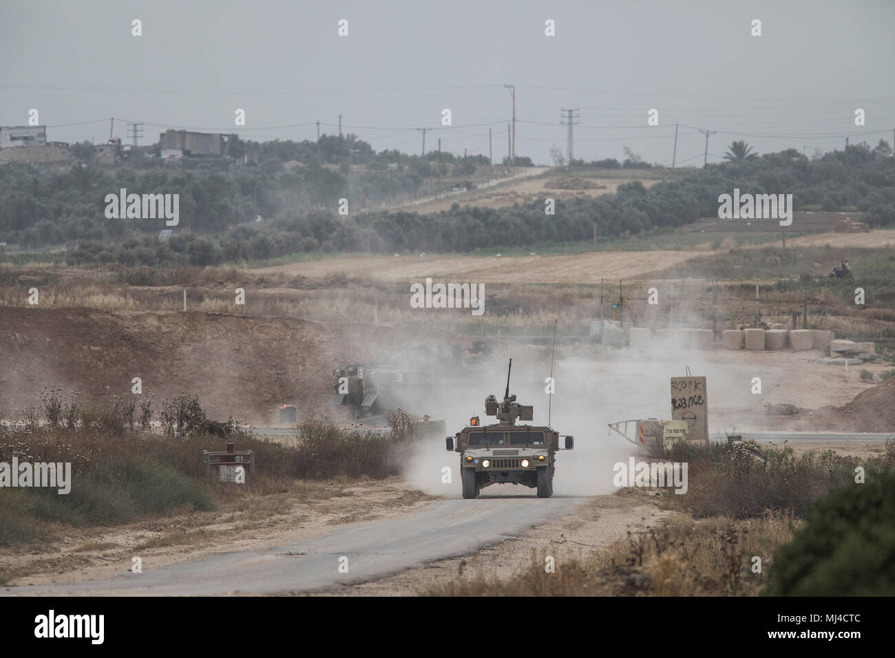 Nahal Oz, Israel. 04th May, 2018. A picture taken from the Israeli side shows an Israeli Humvee driving along the Israel-Gaza border near Nahal Oz, Israel, 04 May 2018. Palestinians are protesting for the 6th Friday in a row as part of a six-week long protest, along the Gaza-Israel border, to demand returning to their homes that they were expelled from during the 1948 war that marked Israel's creation. Credit: Ilia Yefimovich/dpa/Alamy Live News Stock Photo