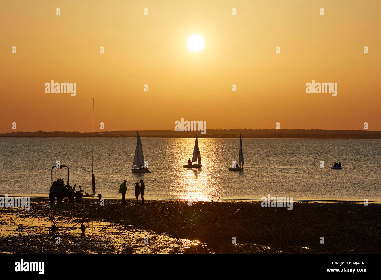 Whitstable, Kent, UK. 4th May 2018: UK Weather.  The sun sets over dinghy sailors enjoying the last rays of a warm day. Temperatures are predicted to be up to 28C for the bank holiday monday. Credit: Alan Payton/Alamy Live News Stock Photo