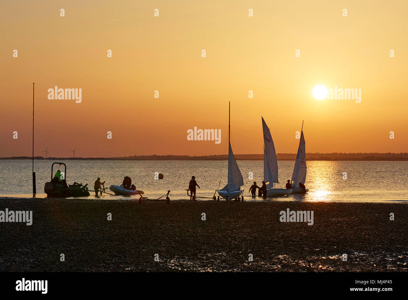 Whitstable, Kent, UK. 4th May 2018: UK Weather.  The sun sets over dinghy sailors enjoying the last rays of a warm day. Temperatures are predicted to be up to 28C for the bank holiday monday. Credit: Alan Payton/Alamy Live News Stock Photo
