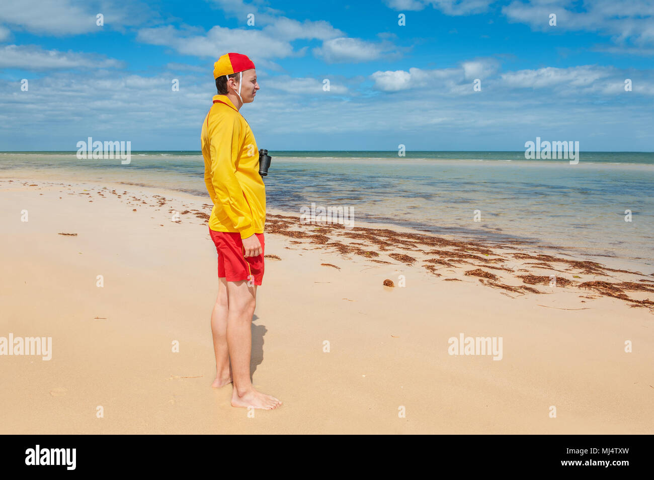 young man  lifesaver  watching the situation on the sea Stock Photo