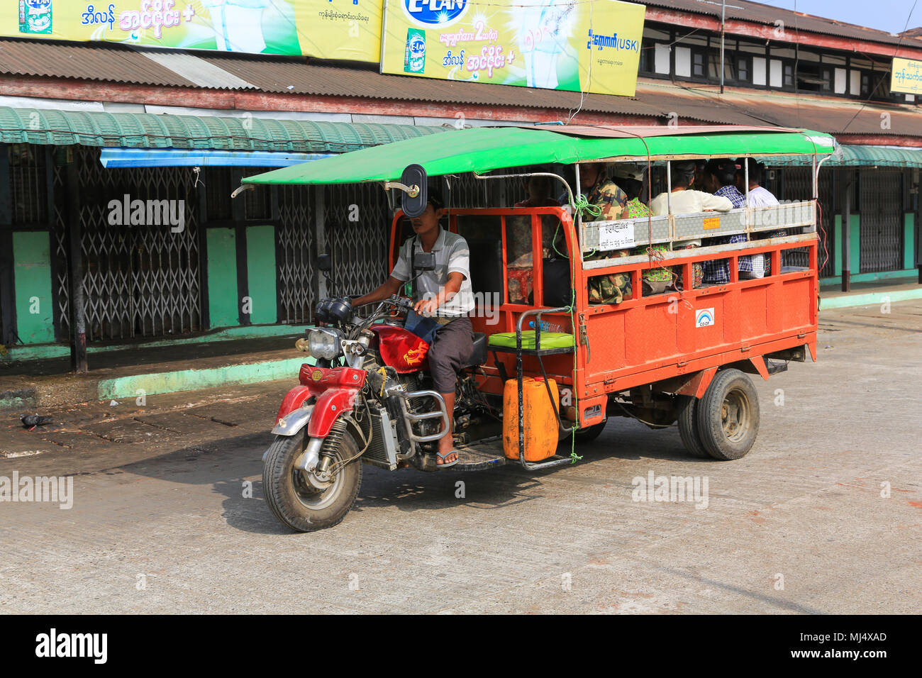 A three wheel truck used as a bus in Maubin located on the Myitmaka River, part of the Irrawaddy Delta in Myanmar (Burma). Stock Photo
