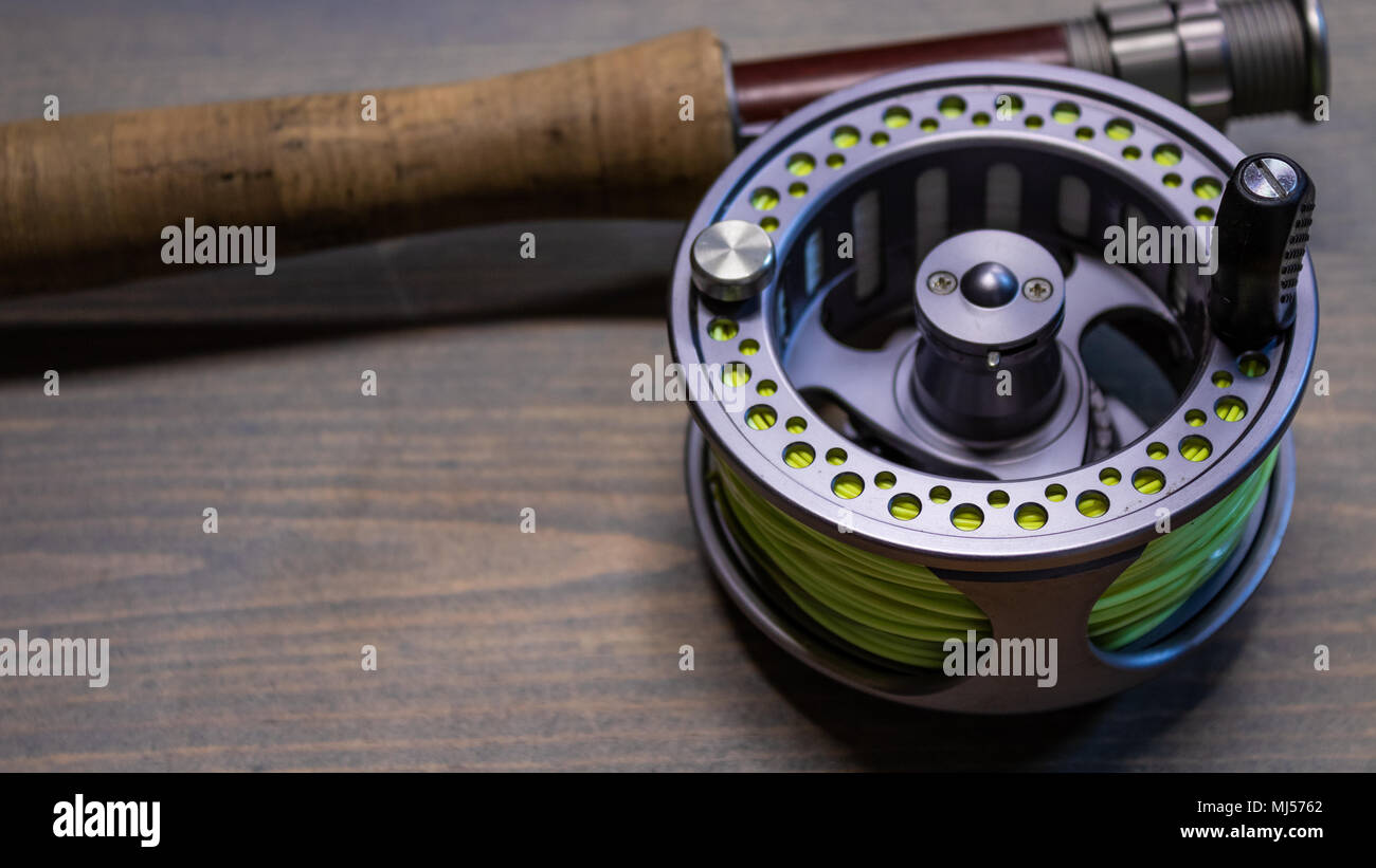 Fly fishing rod with cork handle grip and a left hand retrieve fly fishing reel spooled with fly line Colorado USA Stock Photo