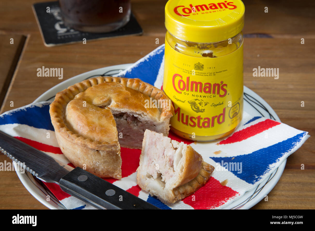 An English pub classic snack of Pork pie with Coleman's English mustard Stock Photo Alamy