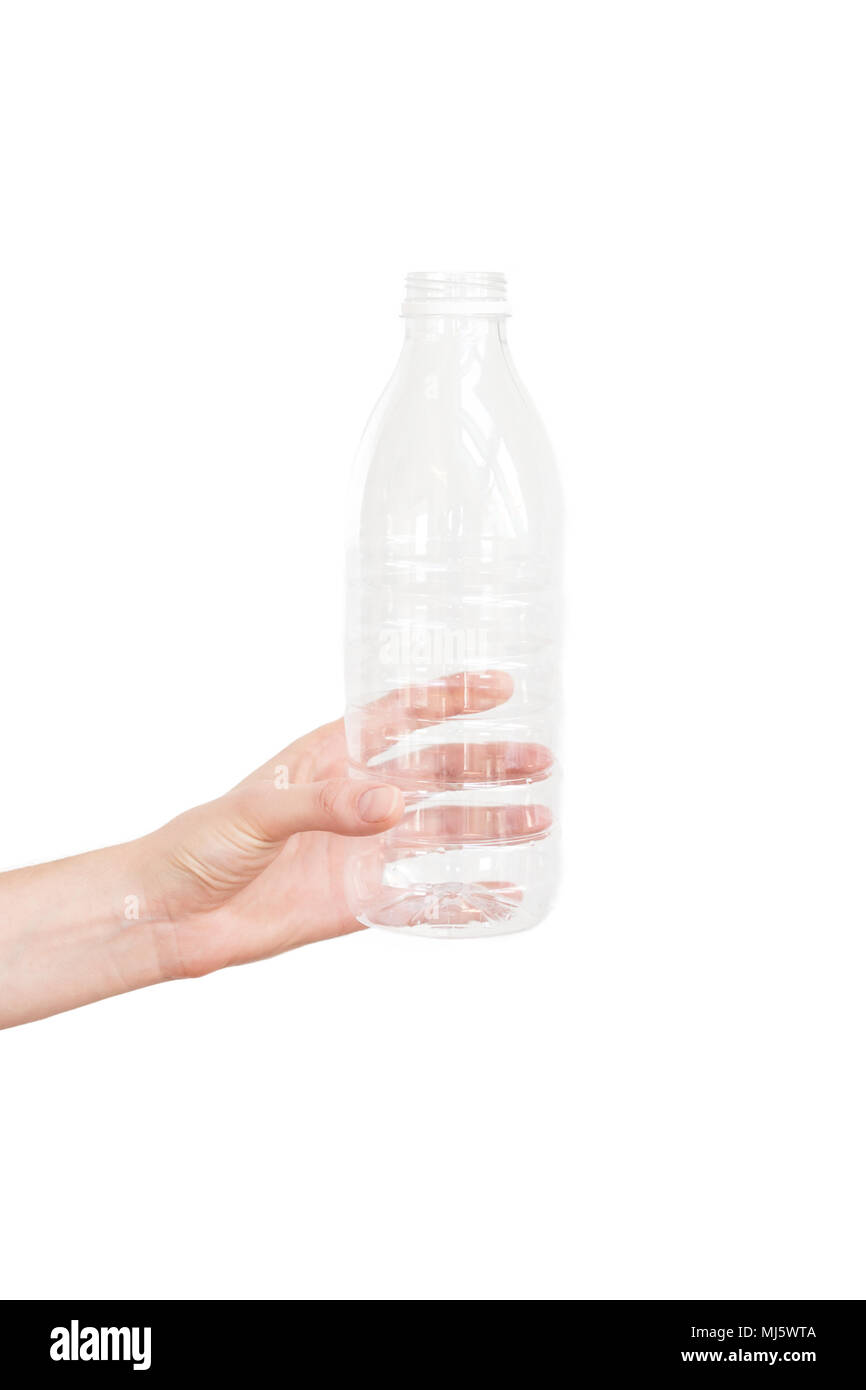 Female hand holding empty plastic bottle isolated on white. Recyclable