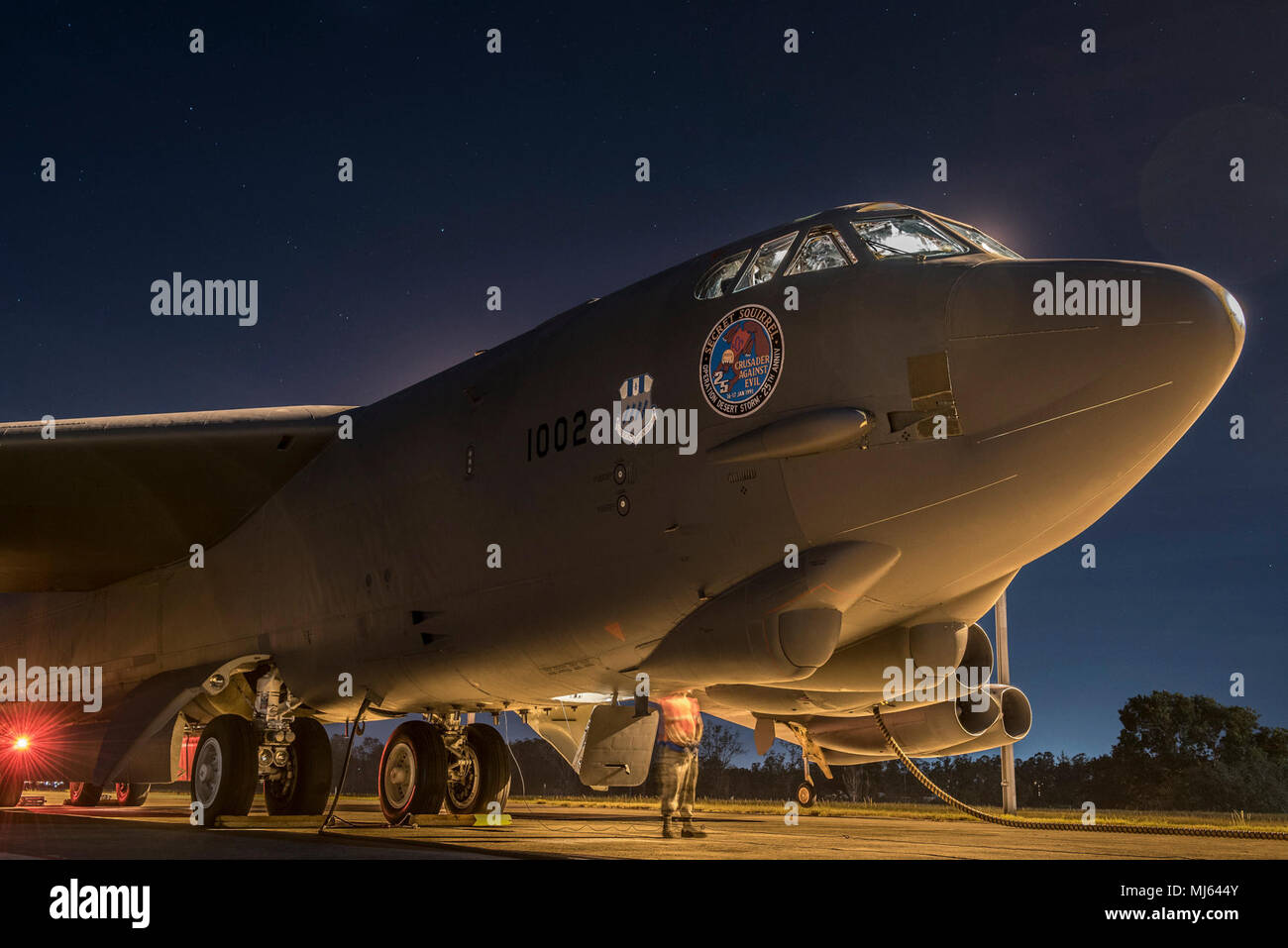 A crew chief assigned to the 20th Expeditionary Aircraft Maintenance Unit and preflight aircrew prepare a B-52H Stratofortress for take-off at Royal Australian Air Force (RAAF) Base, Darwin, Australia, April 3, 2018. A detachment of U.S. Air Force B-52H bombers, aircrew and support personnel deployed to RAAF Darwin to enable the U.S. to train and increase interoperability with Australian joint terminal attack controllers as part of the U.S. Force Posture Initiatives’ Enhanced Air Cooperation program, which builds on air exercises and training between the two air forces. The bombers are current Stock Photo