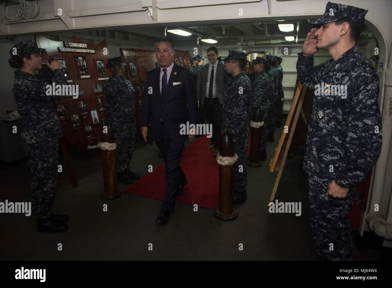YOKOSUKA, Japan (April 4, 2018) U.S. Rep. Mark Takano, of California, and a member of the Committee on Veterans’ Affairs, arrives for a scheduled tour aboard the Navy's forward-deployed aircraft carrier, USS Ronald Reagan (CVN 76). During the tour, Takano visited the flight deck, a berthing and the machinery repair shop. Ronald Reagan, the flagship of Carrier Strike Group 5, provides a combat-ready force that protects and defends the collective maritime interests of its allies and partners in the Indo-Pacific region. (U.S. Navy Image collection celebrating the bravery dedication commitment and Stock Photo