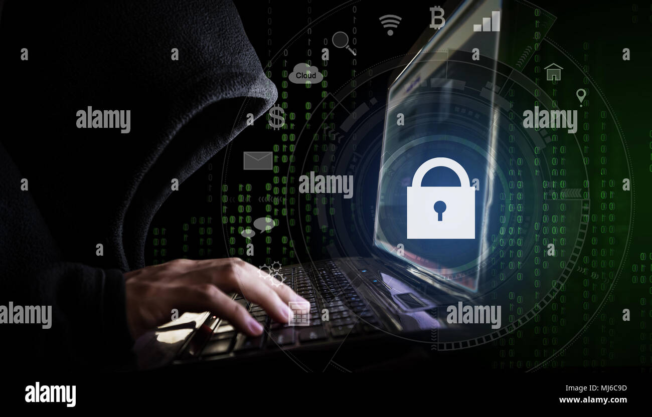 Internet network security system. Hacker in black hoodie using computer laptop and technology lock and application icons Stock Photo