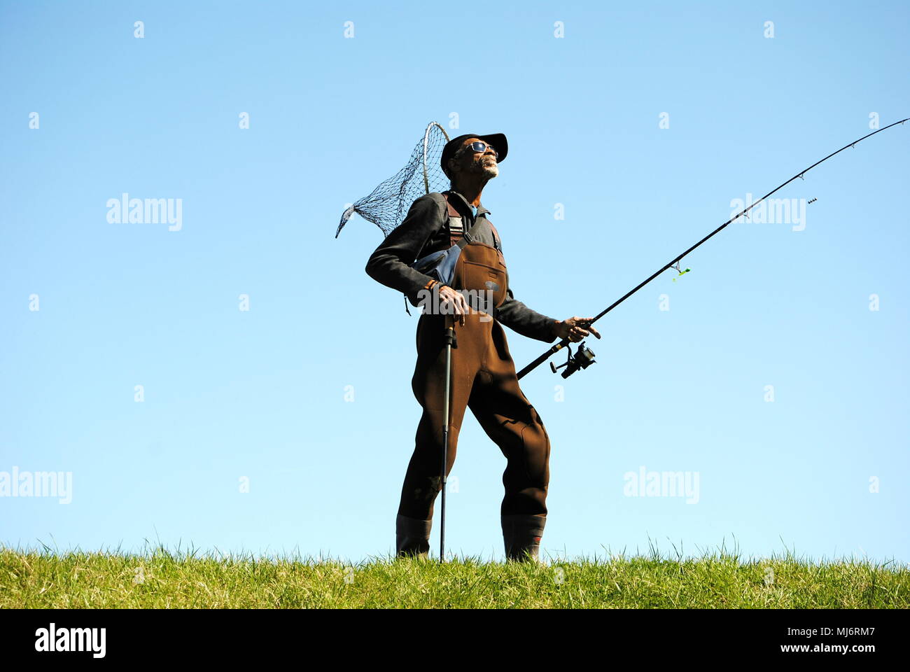 FISHERMAN,STYLES FOR THE AUDIENCE,IN FULL GEAR. Stock Photo
