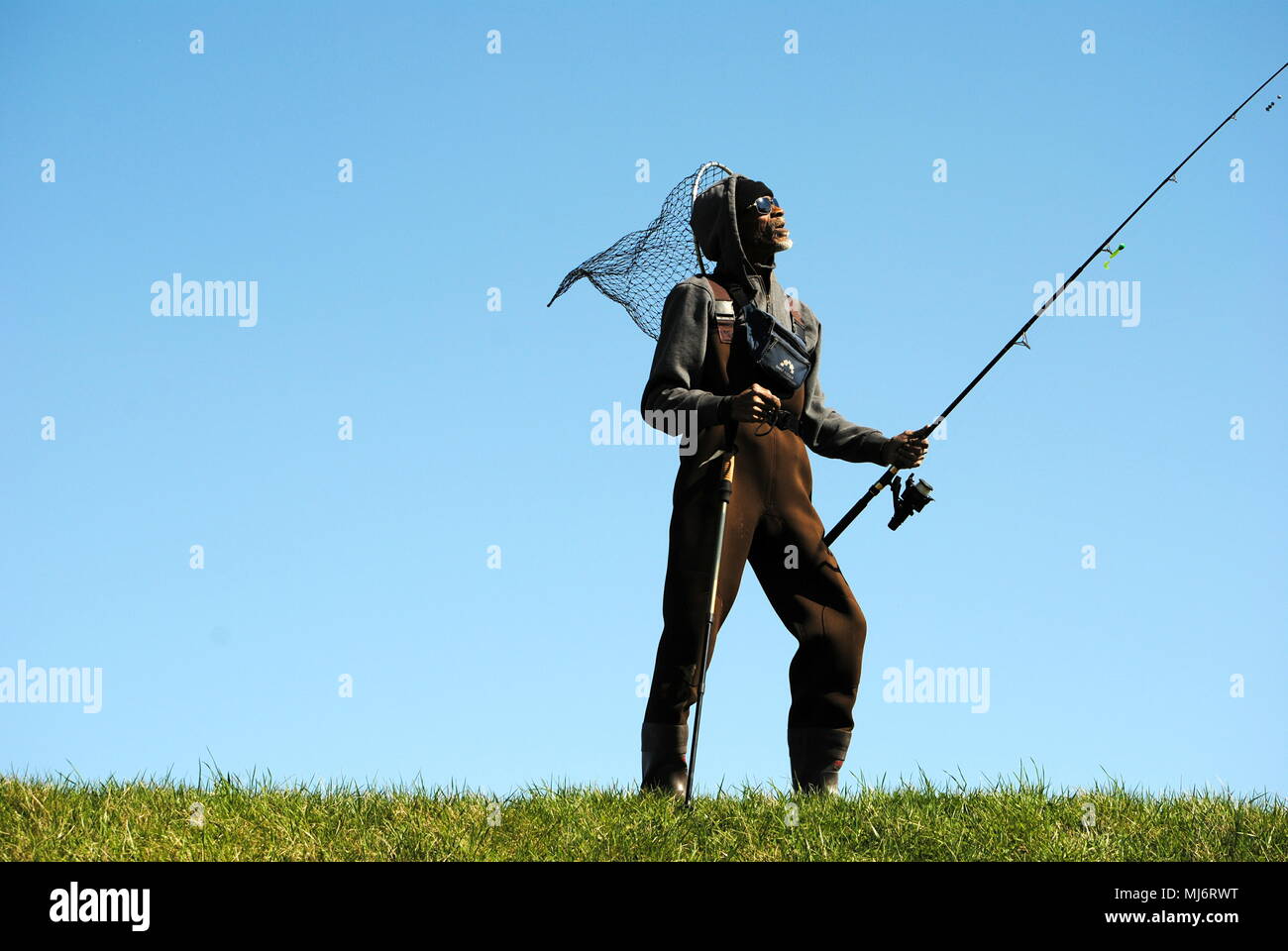FISHERMAN, STYLES FOR THE AUDIENCE, IN FULL GEAR. Stock Photo