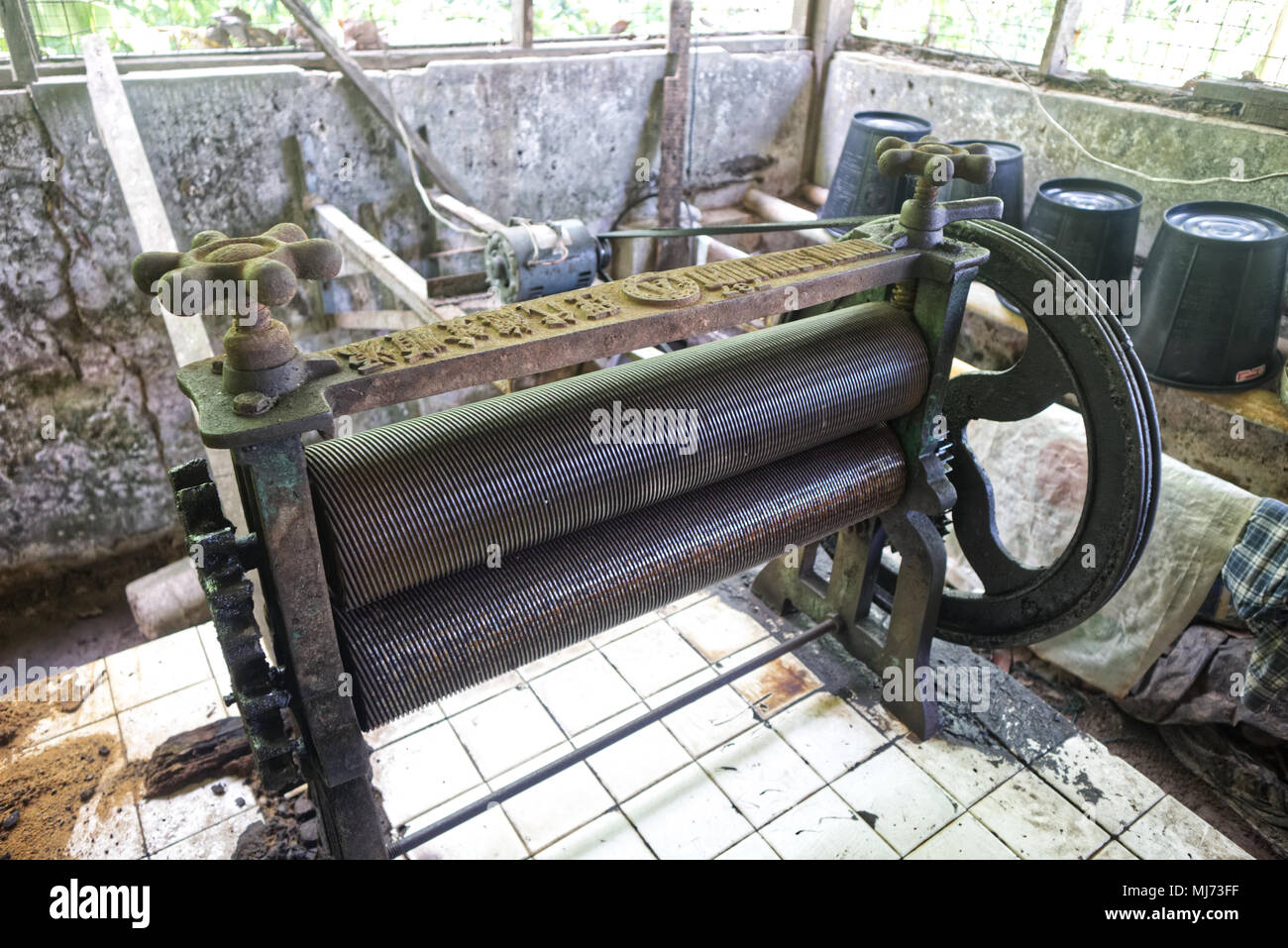 A photograph of a traditional milling machine to produce rubber mats from dried rubber sap Stock Photo