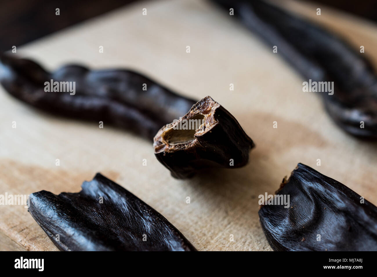 Ripe Carob Pods on wooden surface. food Stock Photo Alamy