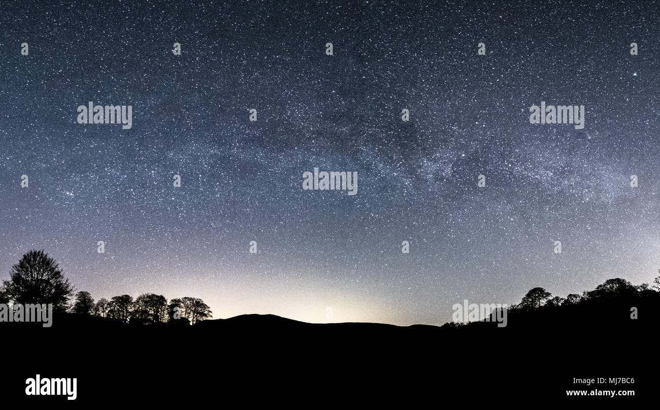 The Milky Way and millions of stars in the night sky above Bolton Abbey and Barden Tower in Norrth Yorkshire Stock Photo