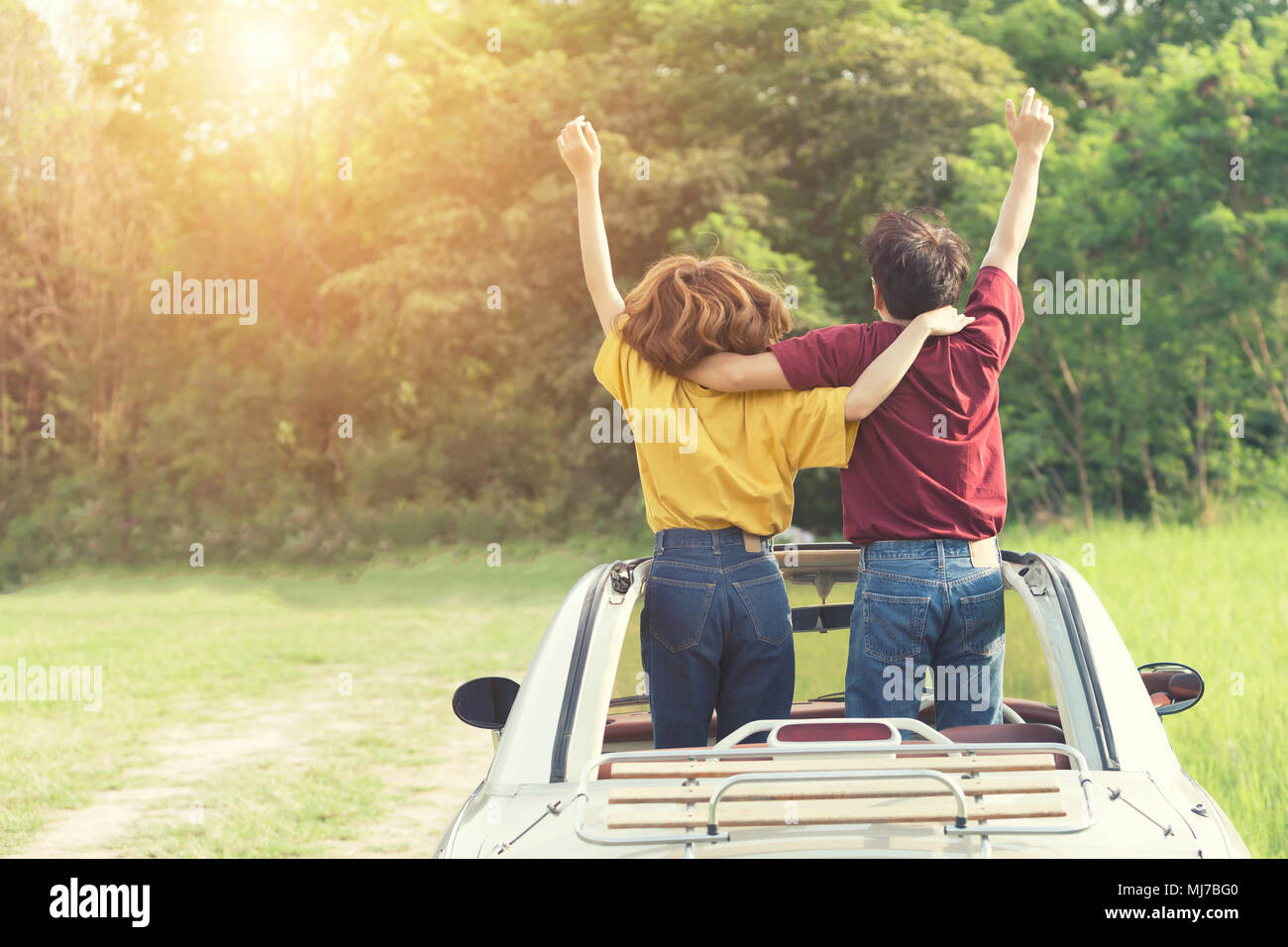 Happy Couple Driving on Country Road into the Sunset in Classic Vintage ...