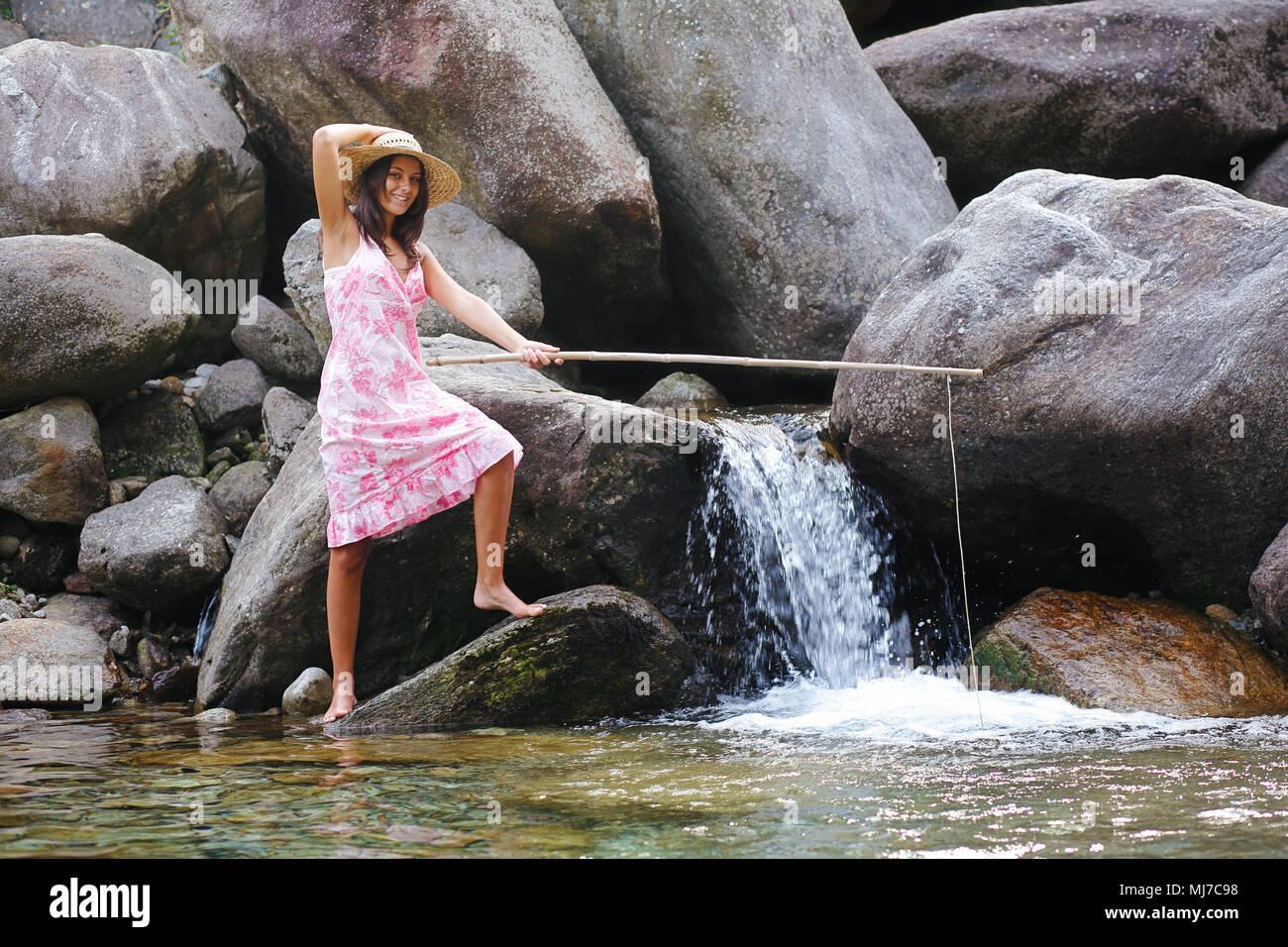 Country girl fishing in a mountain river. Fun and relax Stock Photo - Alamy