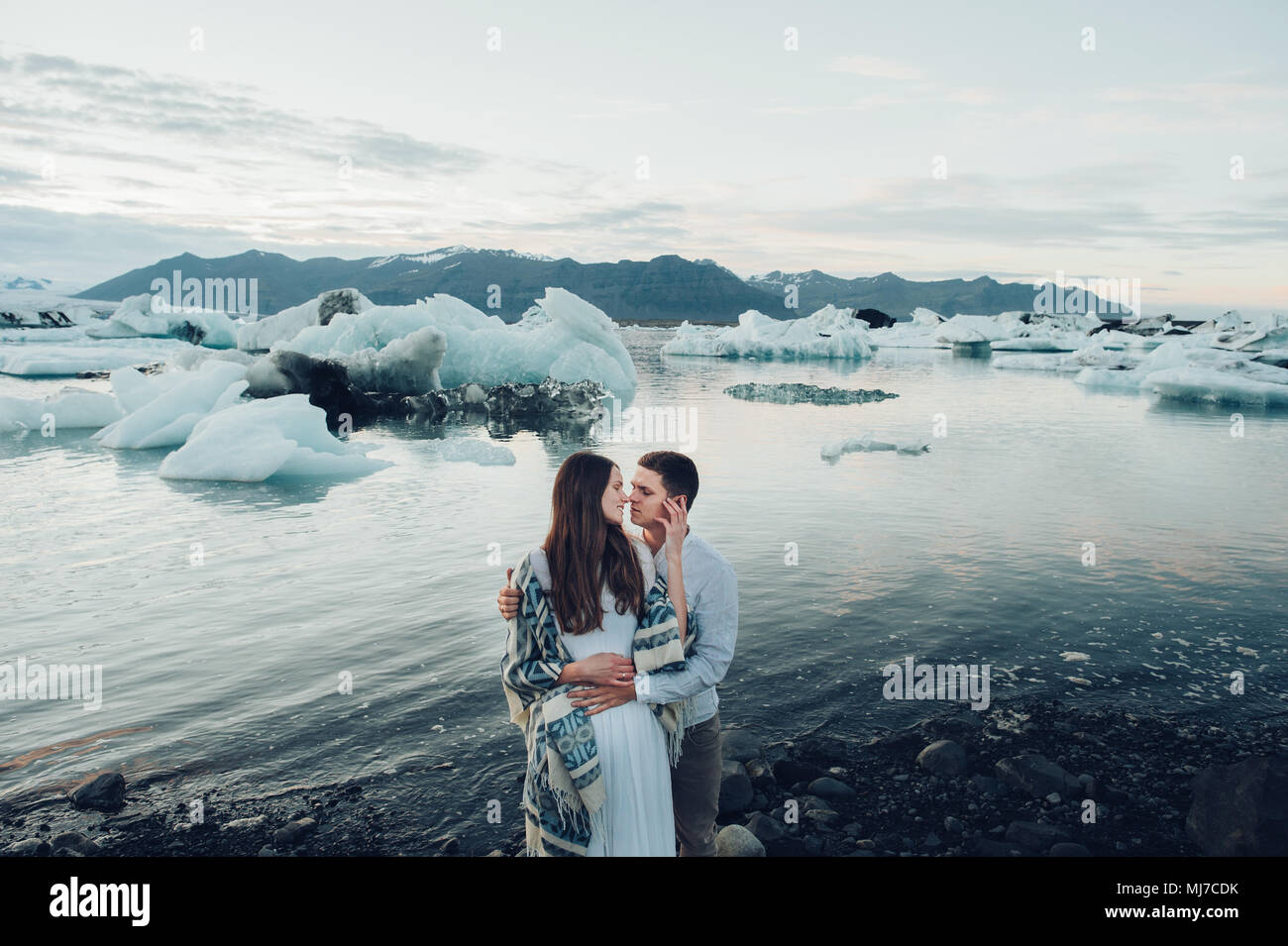 Young stylish couple in love in Iceland. Woman and man embrace and ...