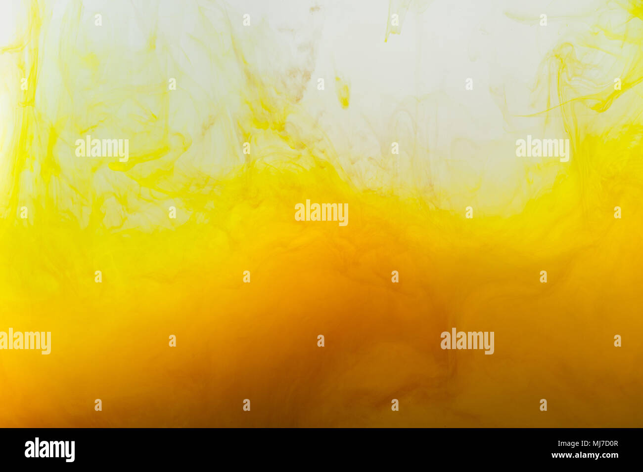 close up view of background with mixing of yellow and brown paints