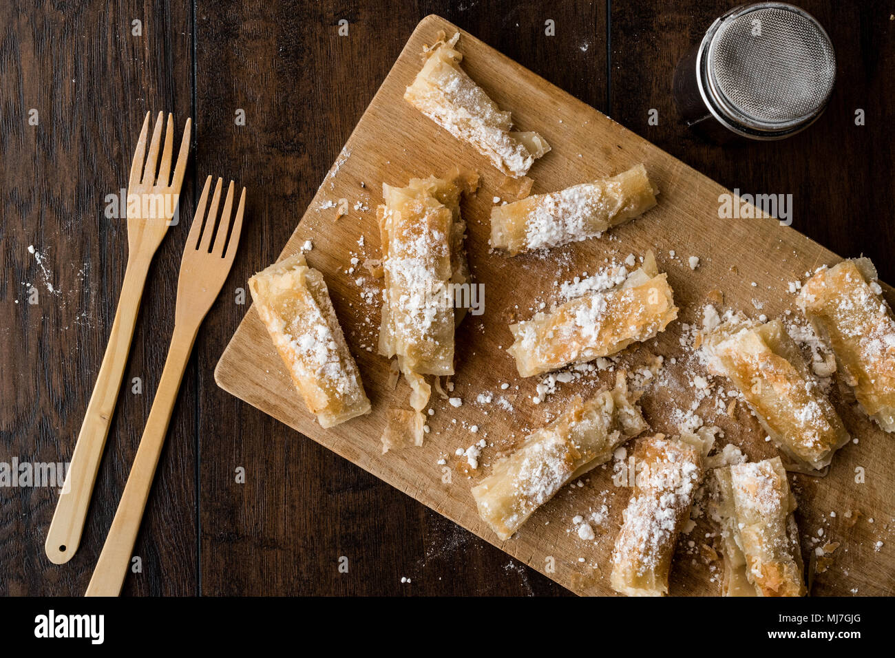 Kurdish Pastry with caster sugar / Kurt Boregi on wooden surface Stock