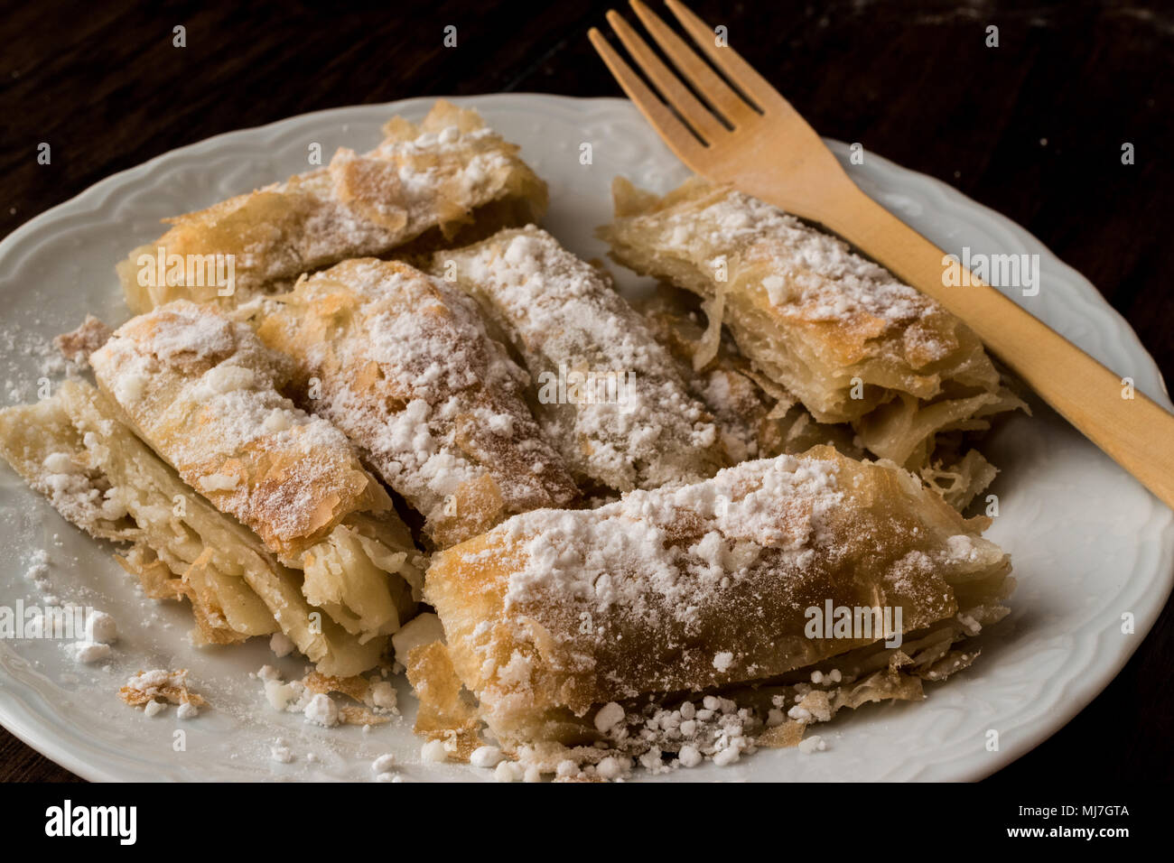 Kurdish Pastry with caster sugar / Kurt Boregi on wooden surface Stock