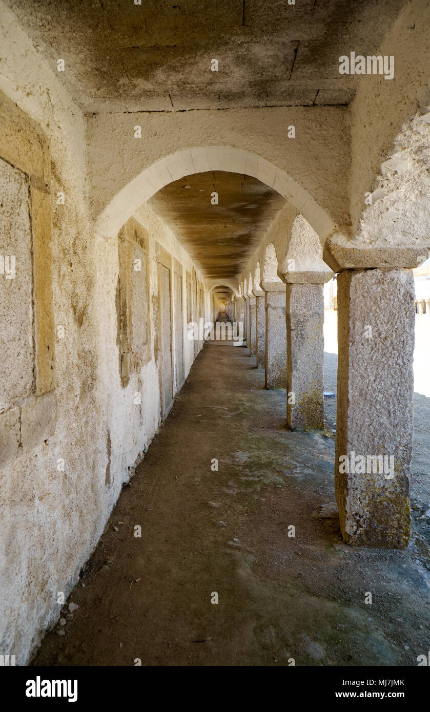 A cloister with cells of the pilgrims in Nossa Senhora do Cabo Church on the cape Espichel in Sesimbra, Portugal Stock Photo