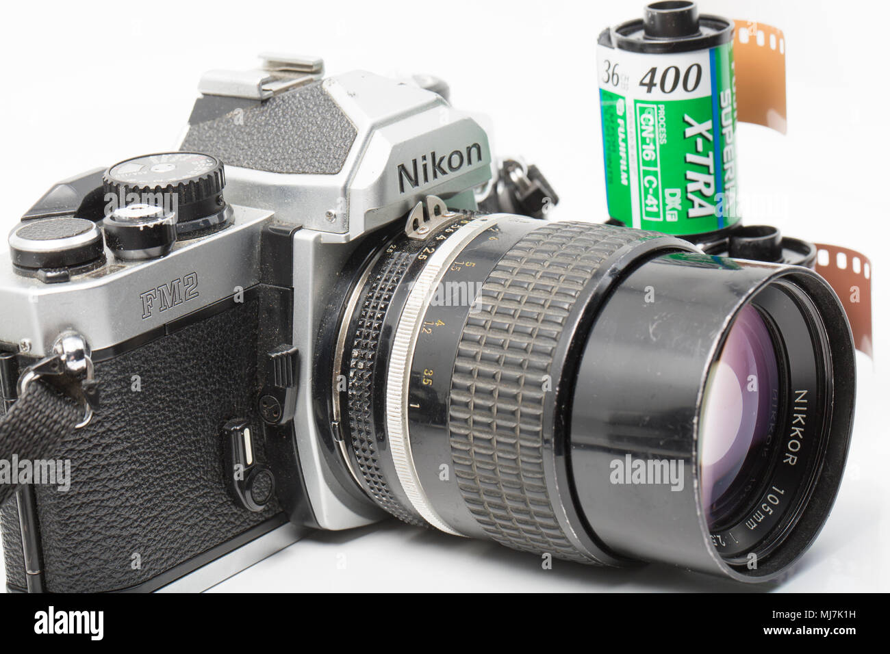 A Nikon FM2 film camera bought in the early 1990s fitted with a Nikkor  105mm 2.5 lens. Dorset England UK. It is pictured with some rolls of Fuji  Film Stock Photo - Alamy