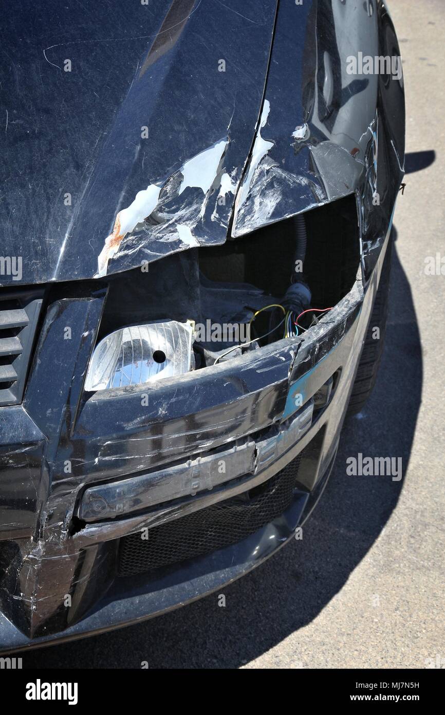 Generic car with dented front wing. Vehicle accident result. Stock Photo
