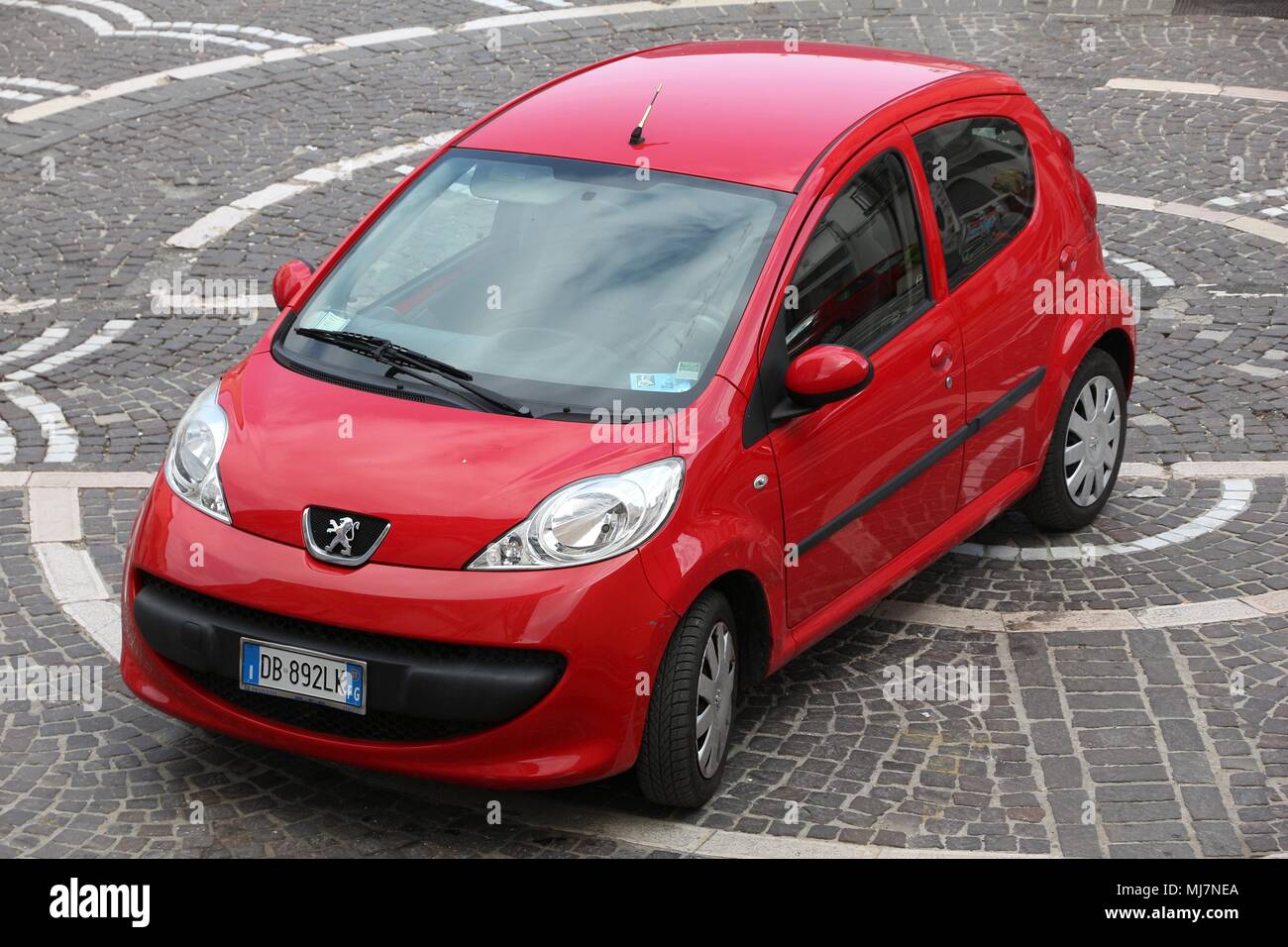 APULIA, ITALY - JUNE 6, 2017: Peugeot 107 red city car parked in Italy. There are 41 million motor vehicles registered in Italy. Stock Photo
