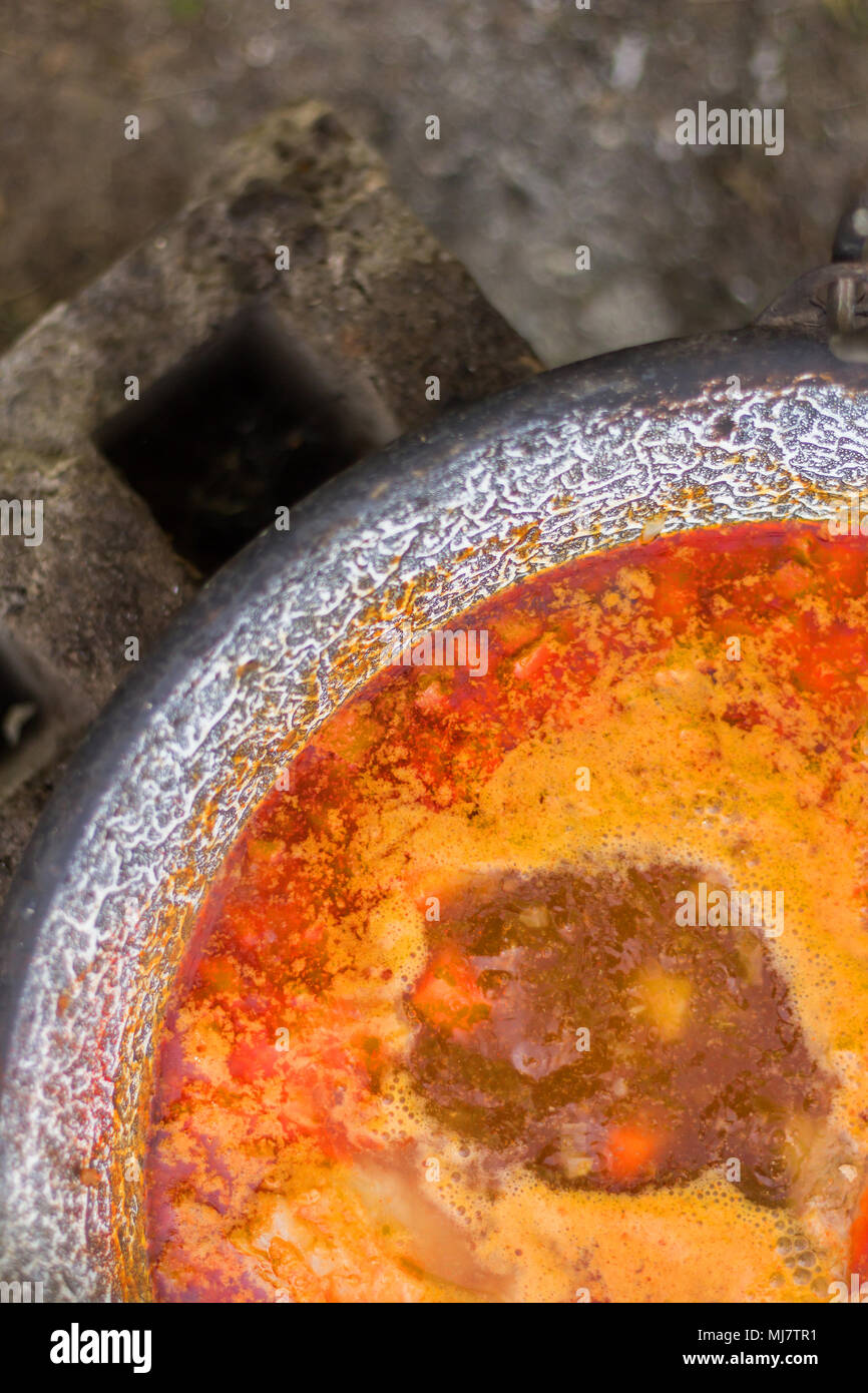 Gulyas stew boiling in a cauldron Stock Photo