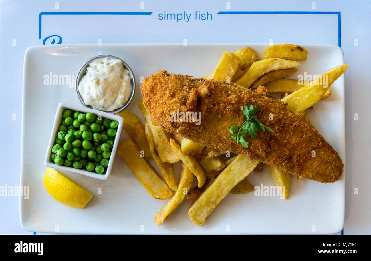 A dish of plaice and chips with peas and tartare sauce, Pier One fish restaurant, Connaught Avenue, Frinton-on Sea, Essex, England Stock Photo