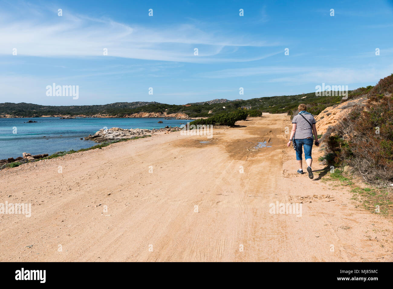 woman walking on caprera island near to maddalena island ,wich you reach by ferry from sardinia Stock Photo