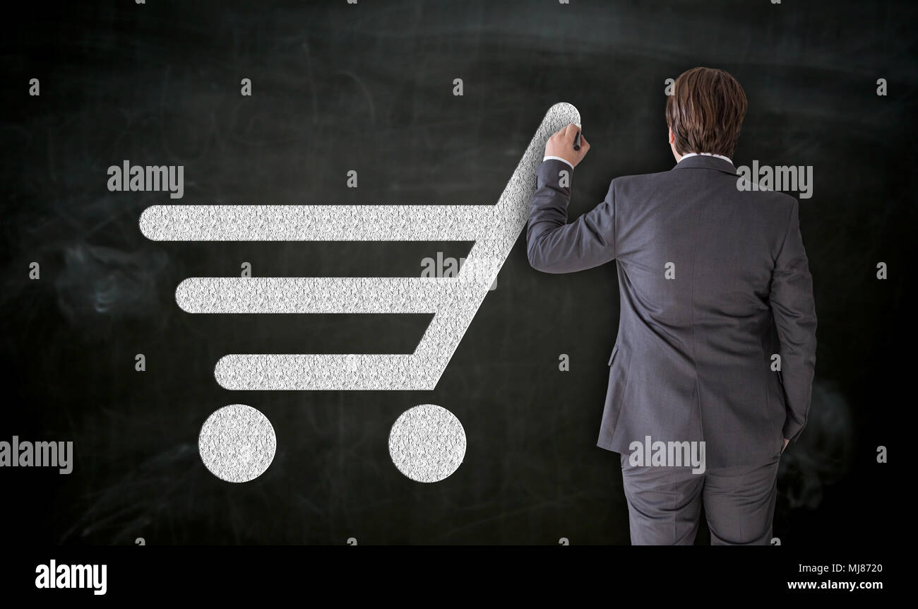 Businessman paints shopping cart on blackboard Concept. Stock Photo