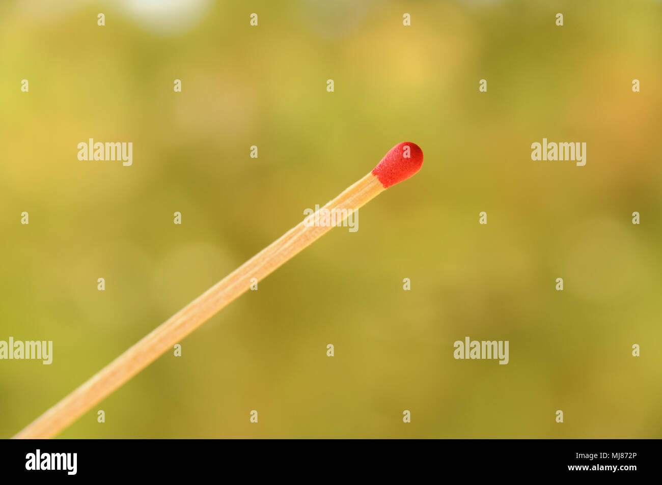 Single matchstick on blurred background Stock Photo