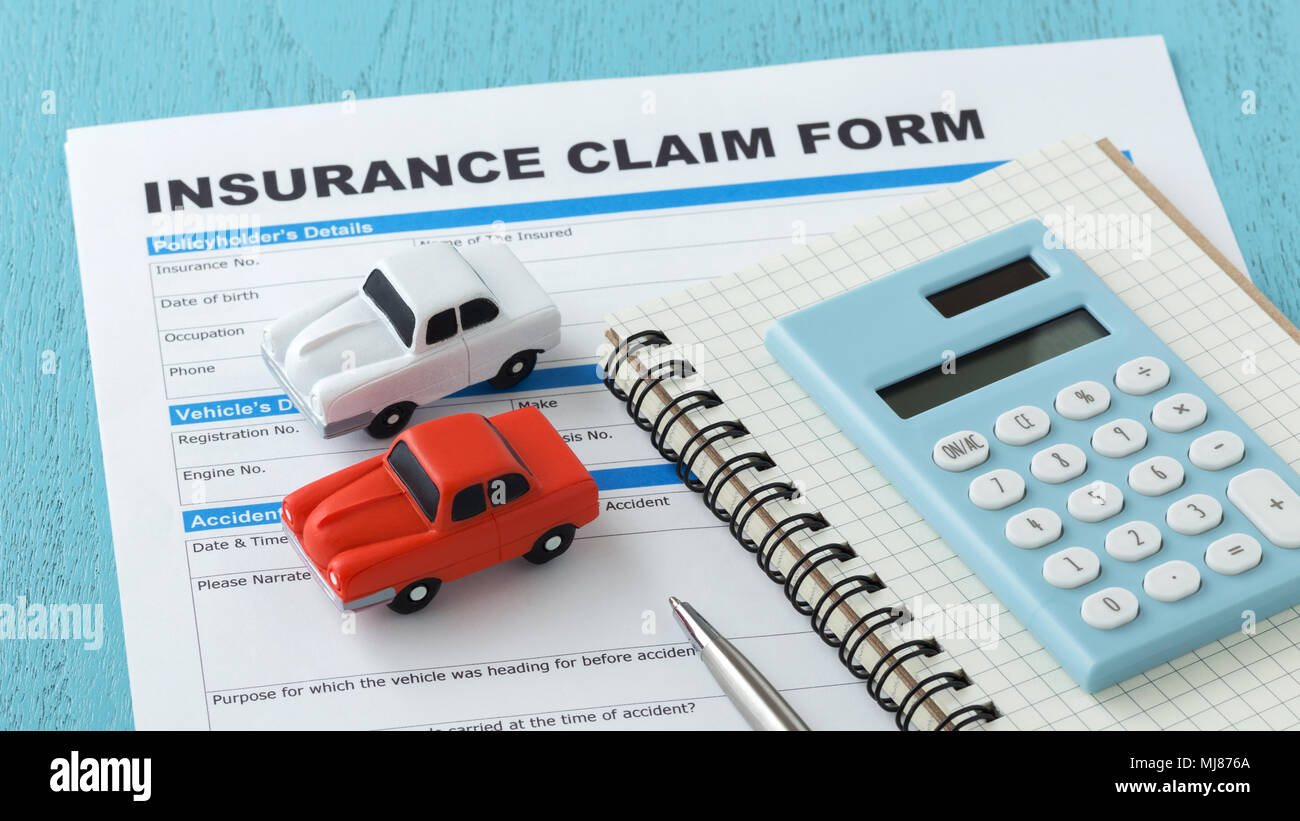 Car insurance claim form with calculator Stock Photo