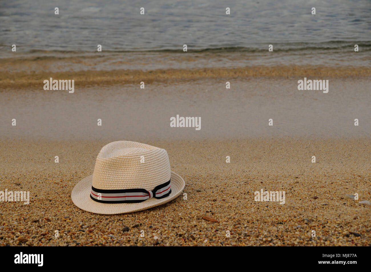White hat on the sandy beach Stock Photo