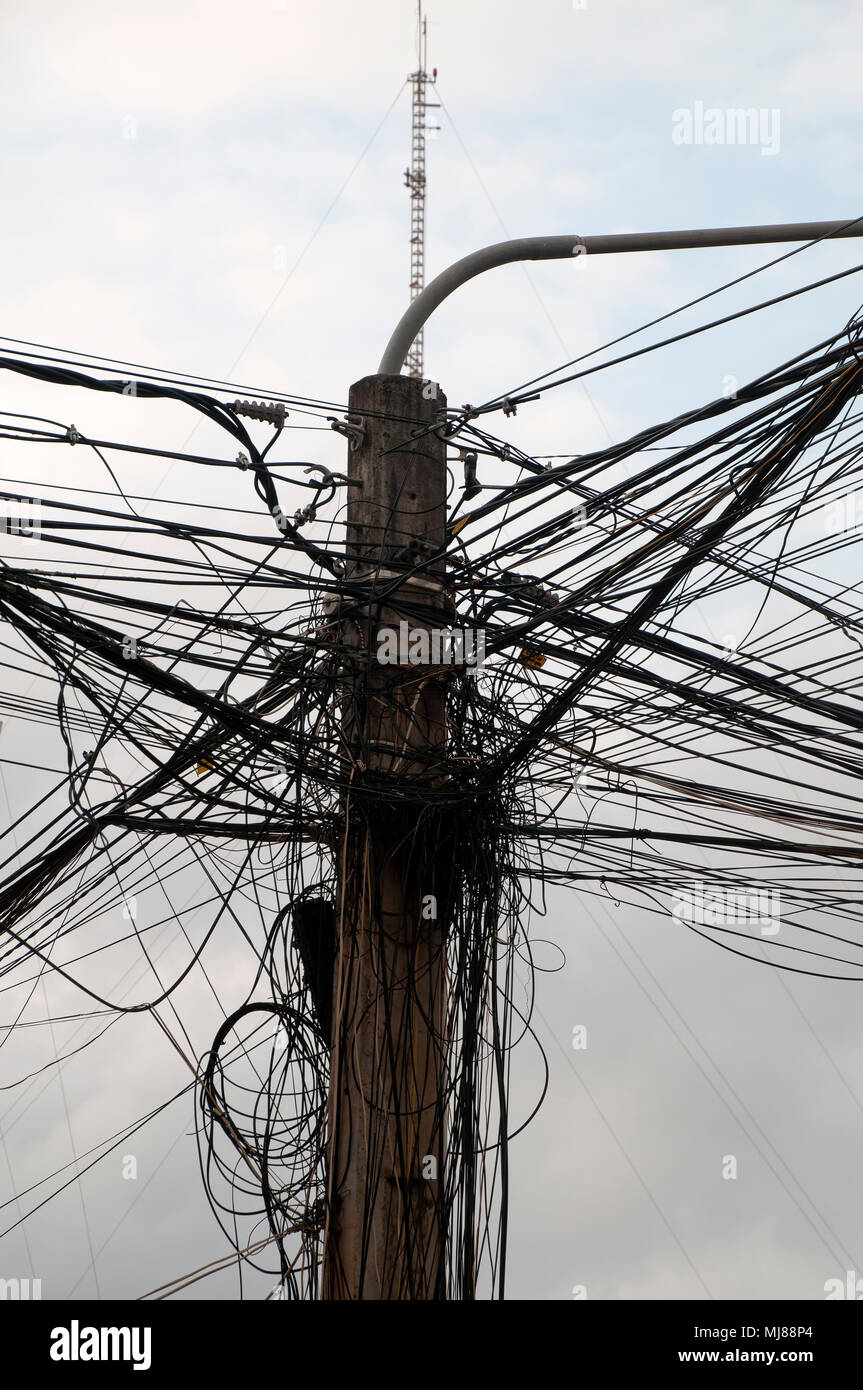 Kampot Cambodia, power pole with typical electrical wiring Stock Photo