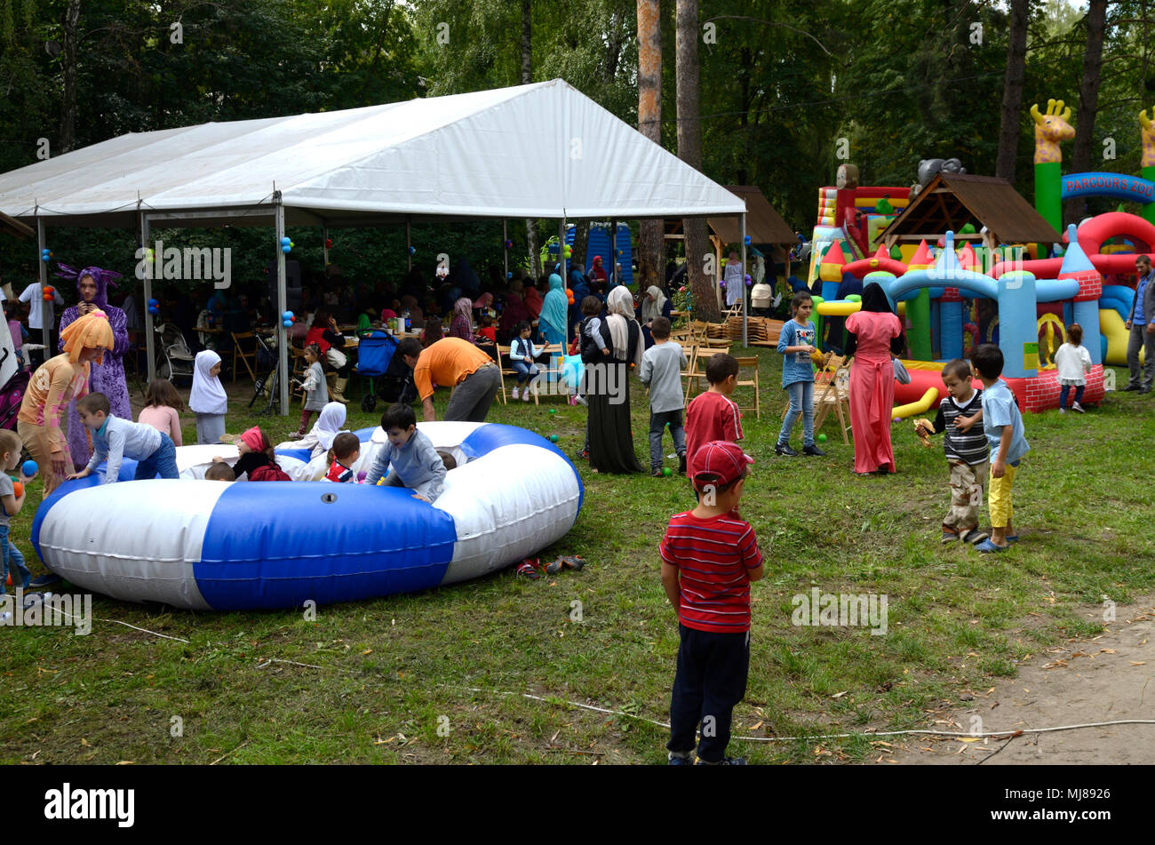 Muslim children playing on a playground. Celebration of Hidirellez (festival of arrival of spring).Kiev, Ukraine Stock Photo