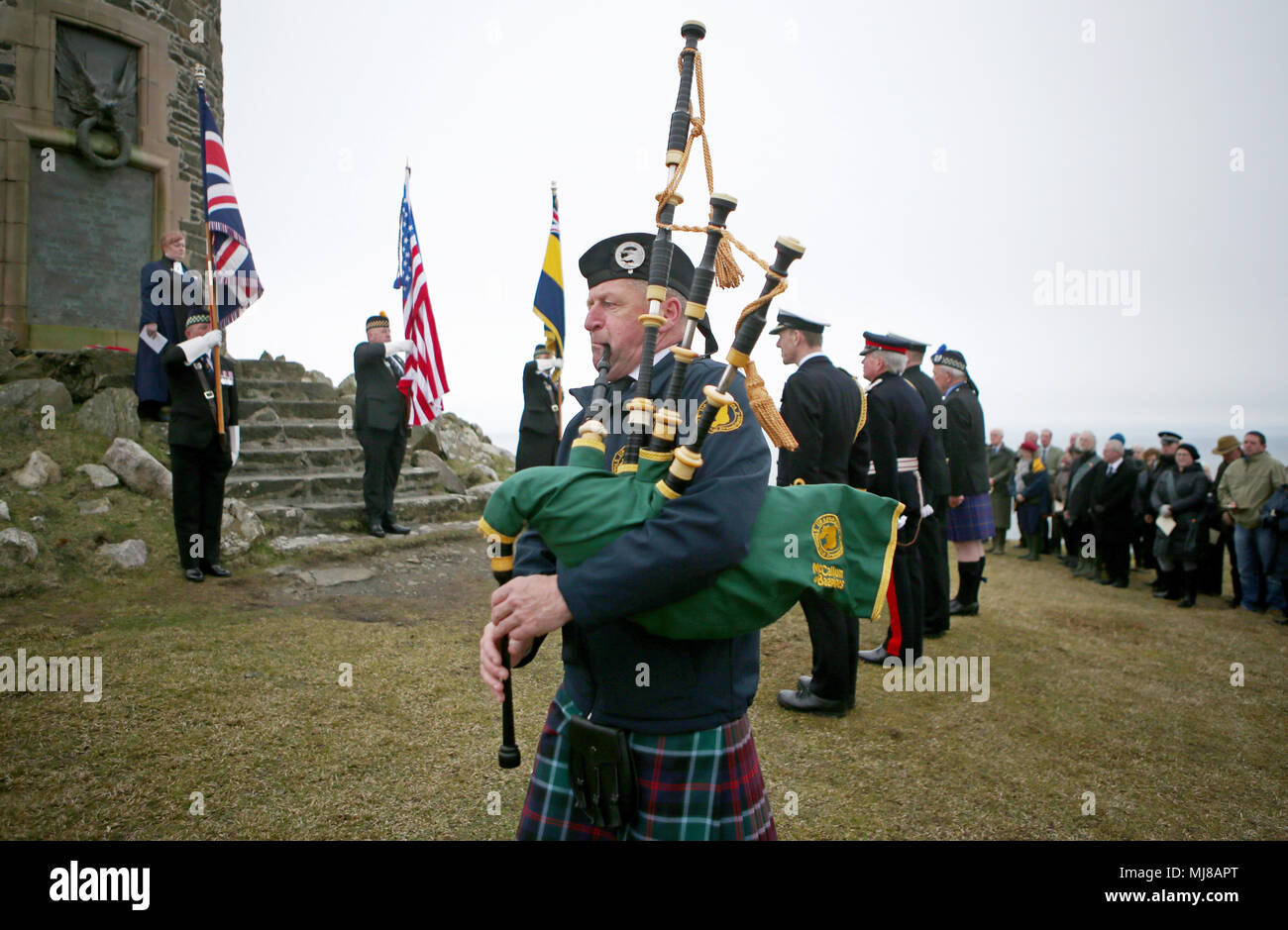 Pipe major Neil MacTaggart, from the Islay Community band, plays during a service at the American Moment at the Mull of Oa on Islay, to remember around 700 First World War soldiers who lost their lives in the sinking of two US ships off the coast of the small Scottish island. Stock Photo