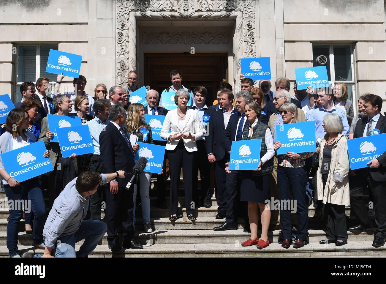 Prime Minister Theresa May (centre) with supporters during a visit to Wandsworth Town Hall, London, where the Conservative Party retained control of Wandsworth Council in the local elections. Stock Photo